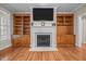 Cozy living room showcasing a fireplace with built-in shelving on each side, perfect for storage and decor at 44 Supreme Dr, Lillington, NC 27546