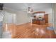 Spacious living room featuring hardwood floors, ceiling fan and an opening to the kitchen island at 44 Supreme Dr, Lillington, NC 27546