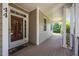 Inviting porch with a wooden deck, columns, and views of the surrounding greenery at 44 Supreme Dr, Lillington, NC 27546