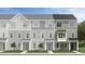 Charming townhomes showcasing a variety of light gray exterior colors, materials, and stylish architectural details at 474 Carolina Springs Dr, Apex, NC 27539