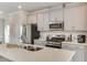 Beautiful kitchen with white cabinets, stainless steel appliances, subway tile backsplash, and stone countertops at 474 Carolina Springs Dr, Apex, NC 27539