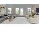 Bright and airy living room with modern gray sofa, chairs, and access to a balcony at 474 Carolina Springs Dr, Apex, NC 27539