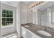 Bathroom featuring dual sinks, granite countertops, and a framed mirror at 503 Bellmeade Bay Dr, Durham, NC 27703