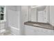 Bright bathroom with a large mirror, granite countertop, white vanity, and tiled floors at 503 Bellmeade Bay Dr, Durham, NC 27703