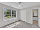 Bright bedroom featuring a large window, closet space, and neutral carpeting at 503 Bellmeade Bay Dr, Durham, NC 27703