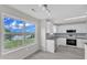 Eat-in kitchen featuring modern white cabinetry, stainless steel appliances, and tile flooring at 503 Bellmeade Bay Dr, Durham, NC 27703