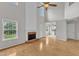 Bright living room with hardwood floors, a cozy fireplace, and tall ceilings at 503 Bellmeade Bay Dr, Durham, NC 27703