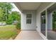 Cozy back porch with a view of the green backyard, trees, and a trampoline at 520 Flip Trl, Cary, NC 27513