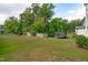 Expansive backyard with mature trees, storage shed, playground and trampoline providing outdoor fun at 520 Flip Trl, Cary, NC 27513