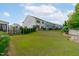 Large backyard with green lawn, black metal fence, and view of the home's rear exterior at 520 Flip Trl, Cary, NC 27513