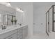 Bright bathroom with double sink vanity, large mirror, walk-in glass shower and tiled floor at 520 Flip Trl, Cary, NC 27513