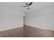 Spacious bedroom featuring hardwood floors, a ceiling fan, and ensuite bath and walk-in closet entrances at 520 Flip Trl, Cary, NC 27513