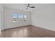Bright bedroom with hardwood floors, a ceiling fan and large window views, offering a tranquil and relaxing space at 520 Flip Trl, Cary, NC 27513