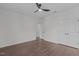 Spacious bedroom featuring hardwood floors, a ceiling fan, and double door closets, creating a minimalist and relaxing space at 520 Flip Trl, Cary, NC 27513