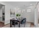 This dining room boasts a modern table setting, complementing the adjacent kitchen and bright interiors at 520 Flip Trl, Cary, NC 27513