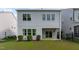 Rear exterior showcasing well-maintained lawn, patio, and windows at 520 Flip Trl, Cary, NC 27513