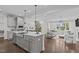 Modern kitchen open to the living room, showcasing a spacious island, sleek appliances, and elegant design at 520 Flip Trl, Cary, NC 27513