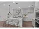Modern kitchen with a large island, stainless steel appliances, and stylish pendant lighting at 520 Flip Trl, Cary, NC 27513