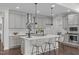 Bright kitchen features a large island with white countertops, pendant lighting, and gray cabinetry at 520 Flip Trl, Cary, NC 27513