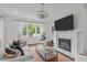 Bright living room with large window views, comfortable seating, a fireplace, and modern decor create an inviting atmosphere at 520 Flip Trl, Cary, NC 27513
