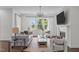 Inviting living room with ample natural light, comfortable seating, and a modern fireplace with mounted television at 520 Flip Trl, Cary, NC 27513