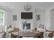 This living room showcases a fireplace, modern light fixture, and seating, creating a cozy and inviting space at 520 Flip Trl, Cary, NC 27513