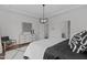 Spacious main bedroom with tray ceiling, modern light fixture, and ensuite bathroom entrance at 520 Flip Trl, Cary, NC 27513