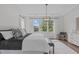 Bright main bedroom with tray ceiling, pendant lighting, large windows and hardwood floors at 520 Flip Trl, Cary, NC 27513