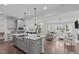 Open concept living space with a modern kitchen, dining area, and cozy living room at 520 Flip Trl, Cary, NC 27513