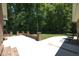 Brick patio with sitting area and view of wooded backyard at 5464 Bass Mountain Rd, Snow Camp, NC 27349