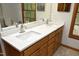 Bathroom features double vanity with quartz countertops and wooden cabinets at 5464 Bass Mountain Rd, Snow Camp, NC 27349