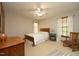 Bedroom features a ceiling fan, natural light, and wood accents at 5464 Bass Mountain Rd, Snow Camp, NC 27349
