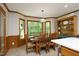 Bright dining room with lots of natural light, wood-paneled walls and views of the backyard at 5464 Bass Mountain Rd, Snow Camp, NC 27349