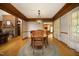 Cozy dining room featuring a classic wood table, decorative light fixture, and hardwood floors at 5464 Bass Mountain Rd, Snow Camp, NC 27349