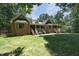 Rear view of the brick home with multiple gables and a covered porch at 5464 Bass Mountain Rd, Snow Camp, NC 27349
