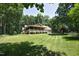 Beautiful brick home featuring a large lawn, covered porch and mature trees at 5464 Bass Mountain Rd, Snow Camp, NC 27349