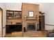 Close up of a brick fireplace with built-in shelving at 5464 Bass Mountain Rd, Snow Camp, NC 27349