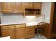 Beautiful kitchen features a built-in desk area with quartz countertops and light wood cabinetry at 5464 Bass Mountain Rd, Snow Camp, NC 27349