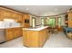 Bright kitchen features a spacious island, stainless steel appliances, light wood cabinetry and eat-in breakfast nook at 5464 Bass Mountain Rd, Snow Camp, NC 27349