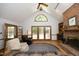 Comfortable living room with vaulted ceilings, fireplace, and wooden french doors at 5464 Bass Mountain Rd, Snow Camp, NC 27349