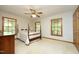 Spacious main bedroom boasts a ceiling fan, multiple windows, and a king bed at 5464 Bass Mountain Rd, Snow Camp, NC 27349