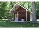 Charming outbuilding with a covered porch, perfect for relaxation and enjoying the outdoors at 5464 Bass Mountain Rd, Snow Camp, NC 27349