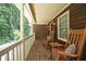 Covered porch with rocking chairs offering a cozy outdoor retreat at 5464 Bass Mountain Rd, Snow Camp, NC 27349