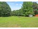 Large, well-maintained backyard with lush greenery and mature trees, offering ample space for outdoor activities at 558 Christys Way, Roxboro, NC 27574