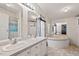 Bathroom features double sinks, large soaking tub, and neutral wallpaper, creating a relaxing atmosphere at 558 Christys Way, Roxboro, NC 27574