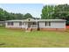 Charming single-story home with light gray siding, brick foundation and covered front porch on lush green lawn at 558 Christys Way, Roxboro, NC 27574