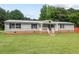 Charming single-story home featuring light siding, dark shutters, metal roof, and inviting front porch at 558 Christys Way, Roxboro, NC 27574