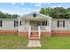 Inviting front porch with white railings and brick steps, perfect for relaxing outdoors at 558 Christys Way, Roxboro, NC 27574
