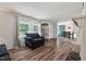 Comfortable living room featuring wood flooring and a display case with windows at 558 Christys Way, Roxboro, NC 27574