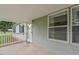 Covered side porch featuring gray siding and white railings, providing a cozy outdoor space at 558 Christys Way, Roxboro, NC 27574